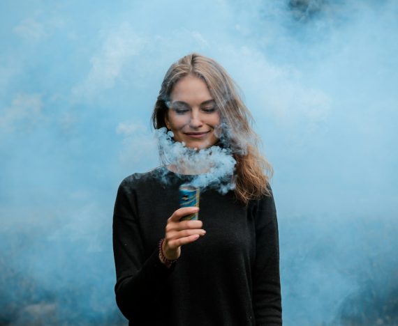 shallow focus photography of woman surrounded by smoke