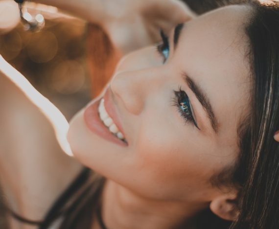 smiling woman with black hair and red lipstick